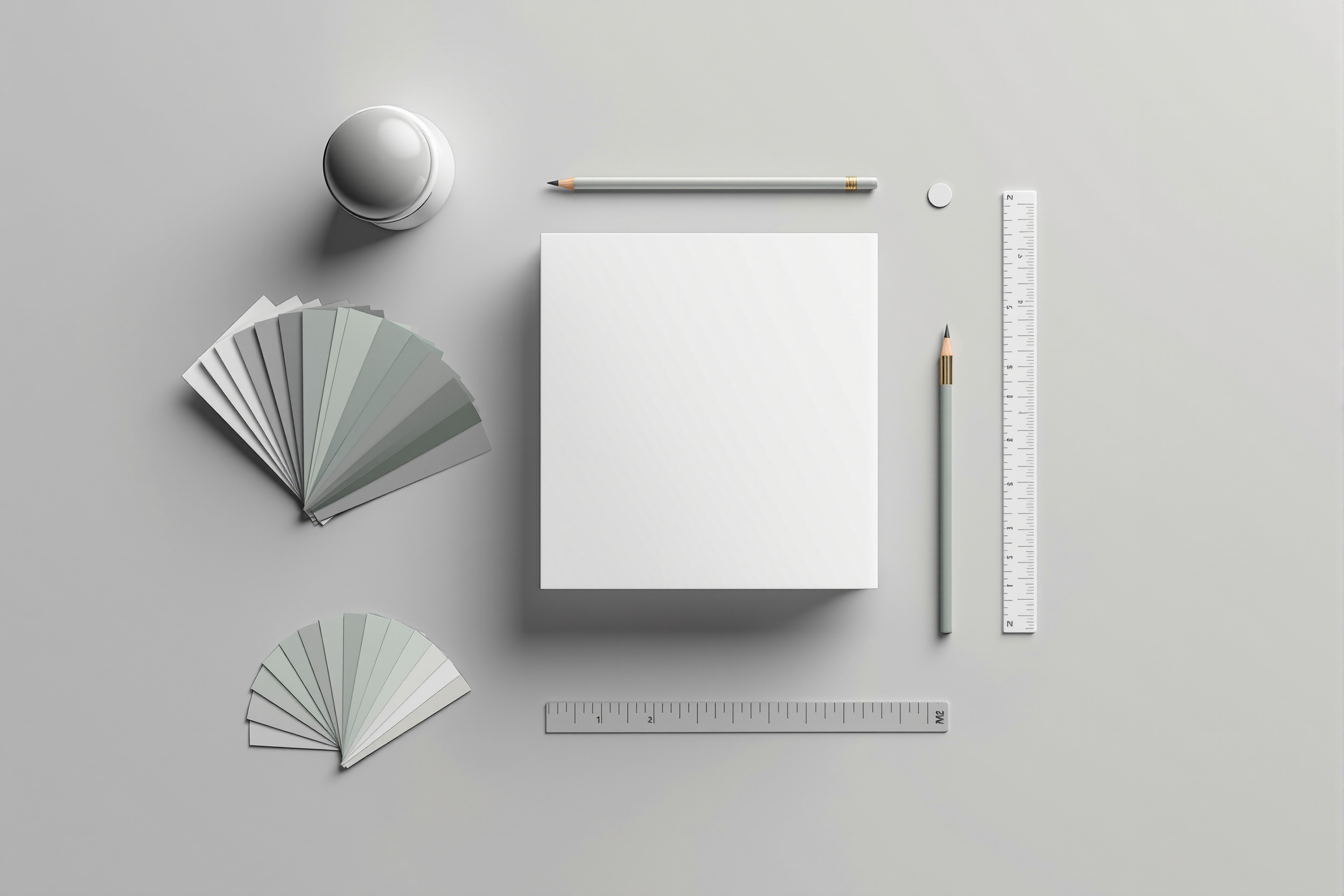 Flat lay of brand and print design materials including business cards and color swatches